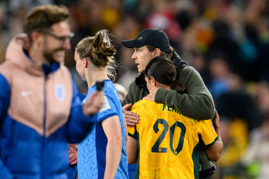 Head coach Tony Gustavsson of Australia hugs Sam Kerr