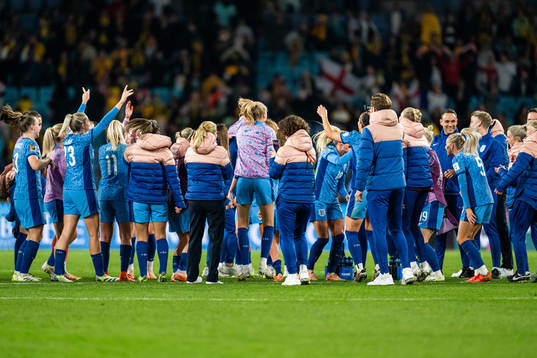 Players and staff of England celebrate