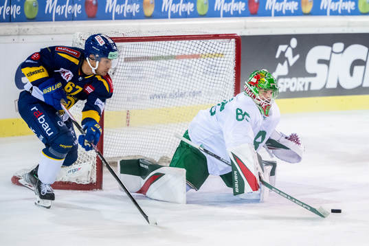 Leon Bristedt of Davos and goalkeeper Christoffer Rifalk of