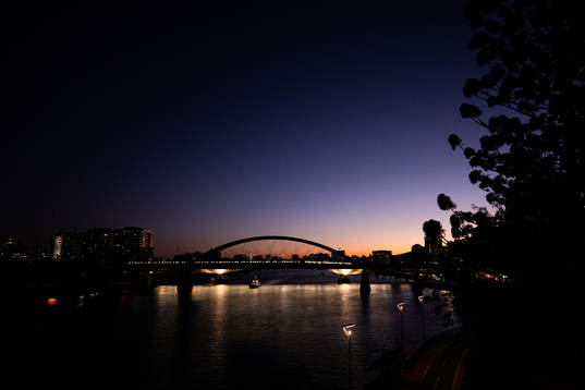 A bridge over Yarra River is seen at sunset