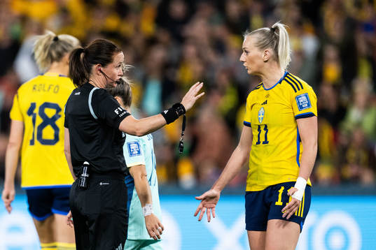 Referee Cheryl Foster and Stina Blackstenius of Sweden