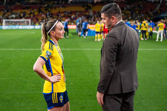Kosovare Asllani of Sweden talks to Bojan Djordjic, of