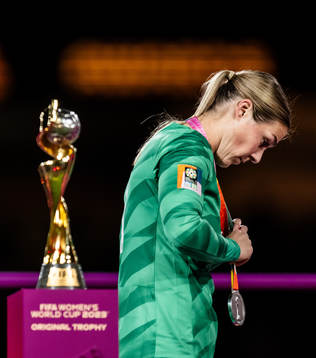 Goalkeeper Mary Earps of England walks past the trophy