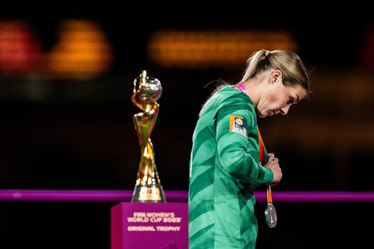 Goalkeeper Mary Earps of England walks past the trophy