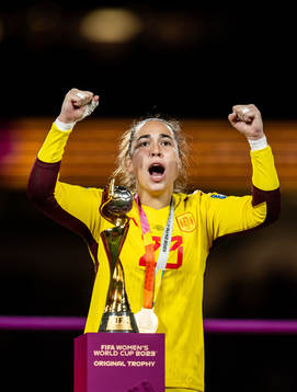 Goalkeeper Cata Coll of Spain celebrates with the trophy