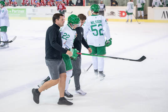 Samuel Jonsson of Rögle is accompanied off the ice by