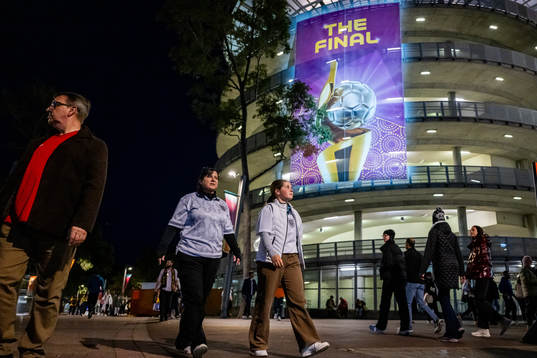 Spectators walk by a sign that reads ”The Final” is