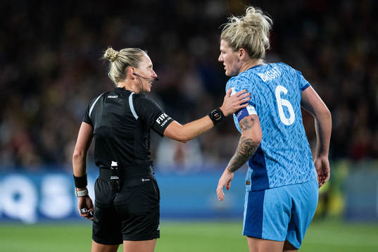 Referee Tori Penso and Millie Bright of England