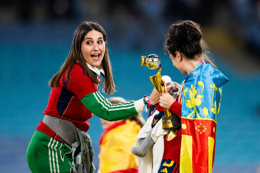Ivana Andres of Spain holds a child that is being bottle