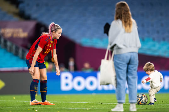 Alexia Putellas of Spain plays football with a child