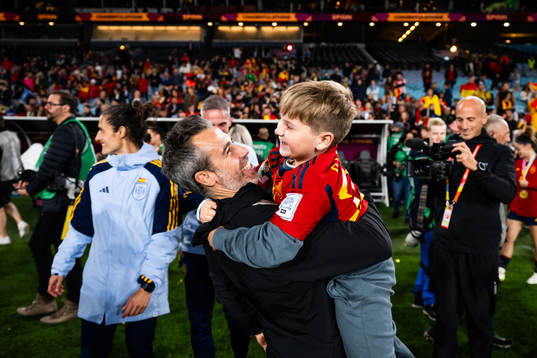 Head coach Jorge Vilda of Spain celebrates with a child