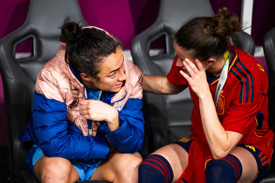 Lucy Bronze of England looks dejected and is consoled by