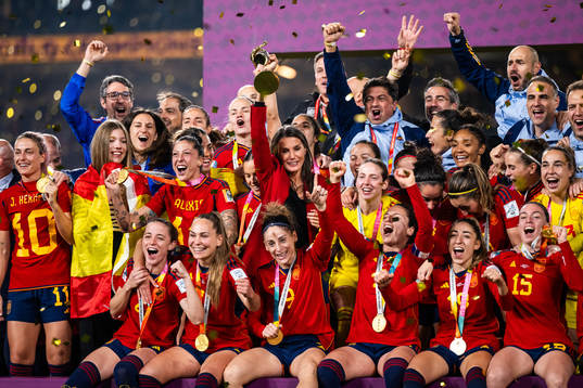 Queen Letizia of Spain celebrates with the trophyand players
