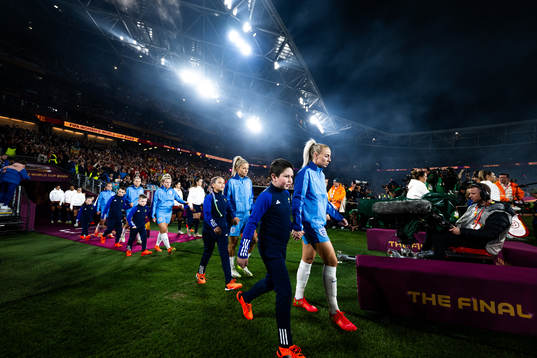 Rachel Daly and Alex Greenwood of England enter the pitch