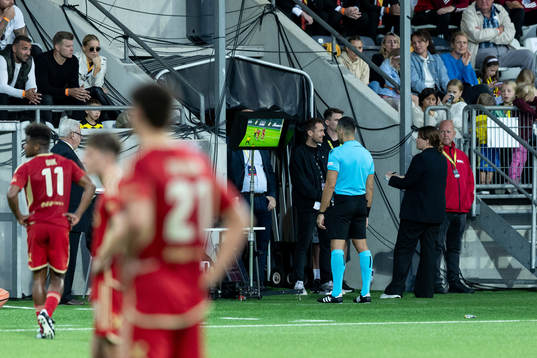 Referee Filip Glova reviews a possible penalty