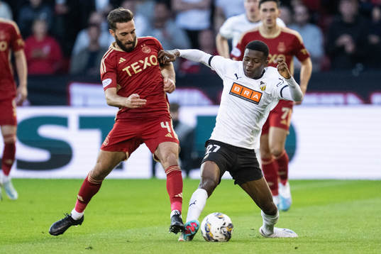 Graeme Shinnie of Aberdeen and Akoua Romeo Amane of Häcken