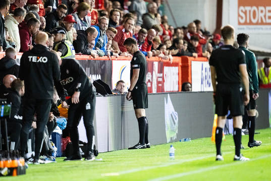 Referee Daniel Siebert watches the VAR screen
