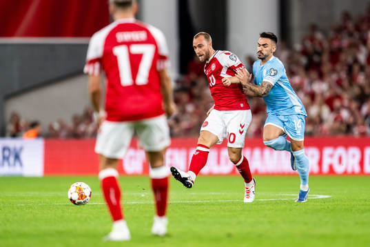 Christian Eriksen of Denmark and Fabio Tomassini  of San