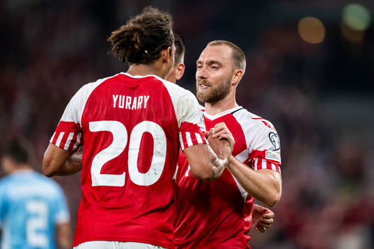 Yussuf Poulsen of Denmark celebrates with Christian Eriksen