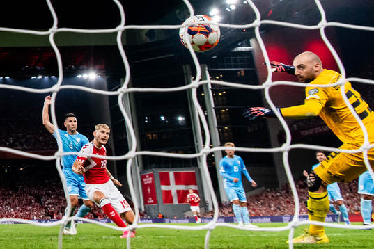 Jonas Wind of Denmark scores the 3-0 goal against