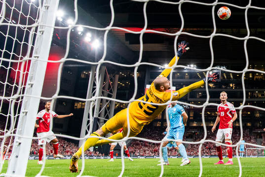 Martin Braithwaite of Denmark against goalkeeper Elia