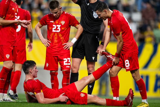 Luka Stankovski gets his leg stretched by Ivan Nikolov of