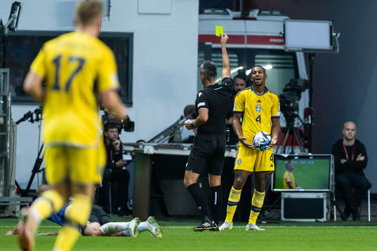 Isak Hien of Sweden is shown a yellow card by referee