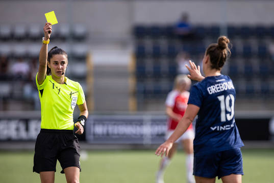 Théa Greboval of Paris FC is shown a yellow card by the