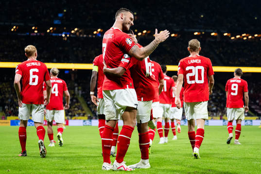 Marko Arnautovic of Austria celebrates with Philip Mwene
