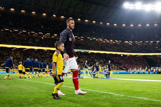 Marko Arnautovic of Austria with a mascot