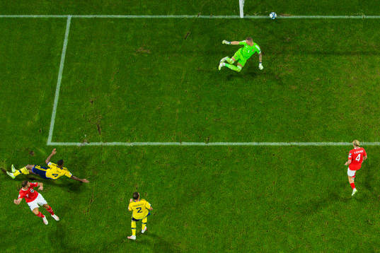 Marko Arnautovic of Austria scores 0-2 behind goalkeeper