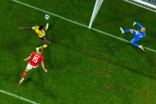 Alexander Isak of Sweden challenges Philipp Lienhart and
