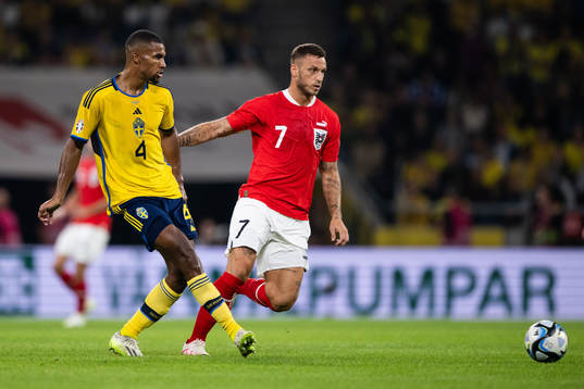 Isak Hien of Sweden and Marko Arnautovic of Austria