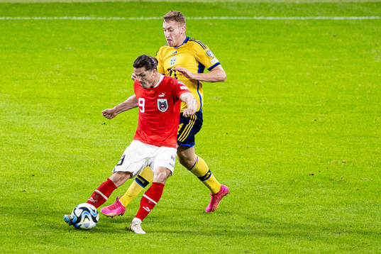 Marcel Sabitzer of Austria and Dejan Kulusevski of Sweden