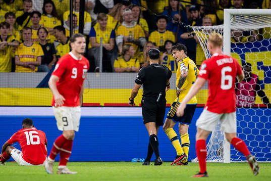 Victor Nilsson Lindelöf of Sweden and referee Serdar
