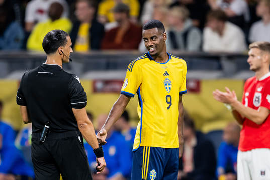 Referee Serdar Gozubuyuk and Alexander Isak of Sweden