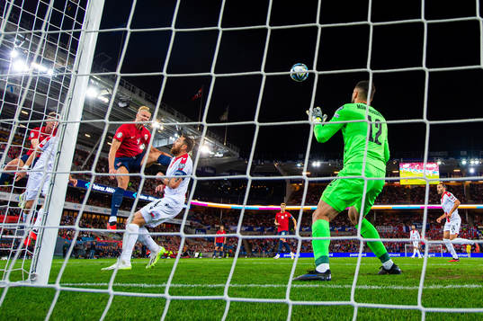 Erling Braut Haaland of Norway scores 1-0 behind goalkeeper