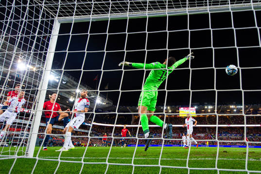 Erling Braut Haaland of Norway scores 1-0 behind goalkeeper