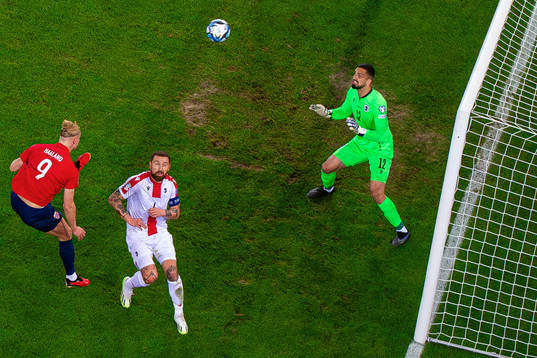 Erling Braut Haaland of Norway scores 1-0 behind goalkeeper