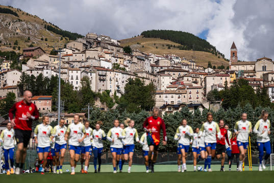The city of Rivisondoli is seen behind players of the