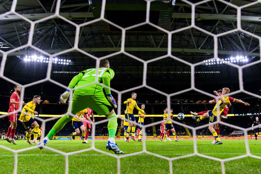 Ion Nicolaescu of Moldova scores 2-1 behind goalkeeper