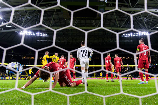 Ioan-Calin Revenco and goalkeeper Dorian Railean of Moldova