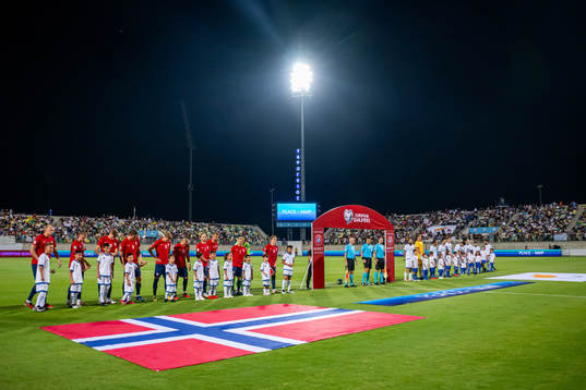 Players of Norway and Cyprus line up