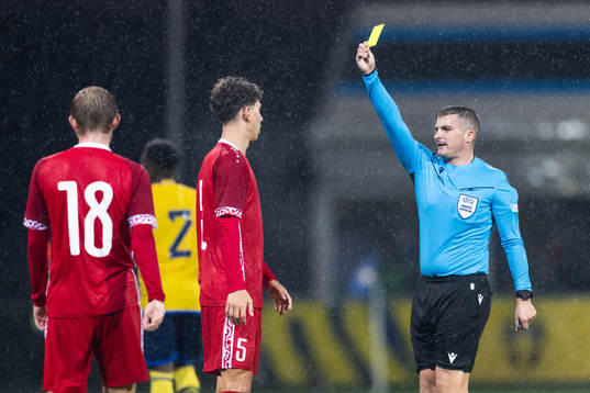 Referee Trustin Farrugia Cann give a yellow card to Doru