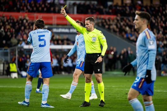 Robin Le Normand of Spain and Referee Tobias Stieler