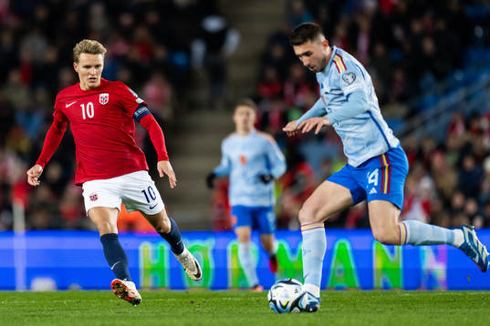 Martin Ødegaard of Norway and Aymeric Laporte of Spain