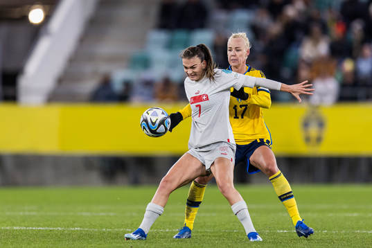 Riola Xhemaili of Switzerland and Caroline Seger of Sweden