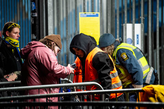 Spectators is visited by security personel outside of the