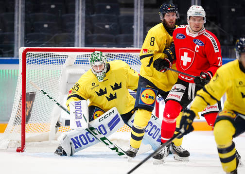 Goaltender Carl Lindbom, Petter Granberg of Sweden and