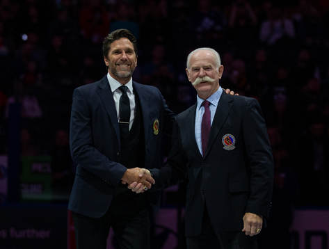Henrik Lundqvist receives his blazer from Lanny McDonald